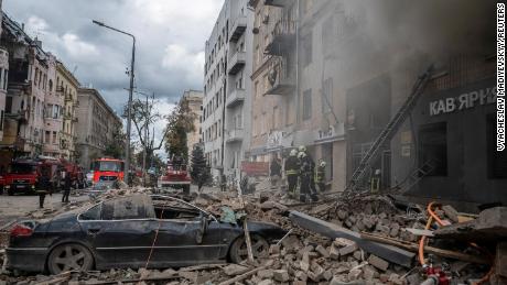 Firefighters work at the site of a residential building hit by a Russian military strike in Kharkiv, Ukraine, on September 6.