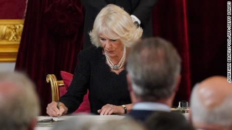 Queen Camilla of Great Britain signs the Oath to Safeguard the Church of Scotland during a meeting of the Membership Councils inside St James's Palace.