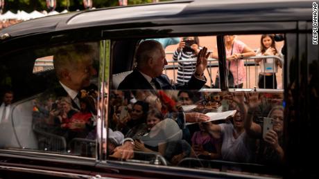 King Charles III arrives at Buckingham Palace to greet his supporters.