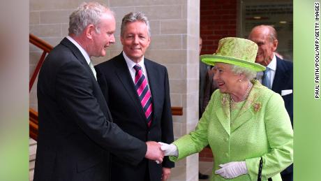 Queen Elizabeth II shakes hands with Northern Ireland Deputy First Minister Martin McGuinness, left, watched by First Minister Peter Robinson and Prince Philip at the Lyric Theatre in Belfast, Northern Ireland, on June 27, 2012.