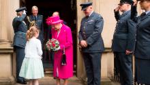 Queen Elizabeth II received a bouquet of flowers from Charlotte Murphy during her visit to the Royal Auxiliary Air Force's 603rd Squadron Headquarters in Edinburgh, Scotland, July 4, 2015.