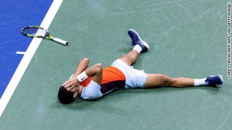 Alcalaz falls to the ground after defeating Francis Tiafoe in the US Open semifinals. 
