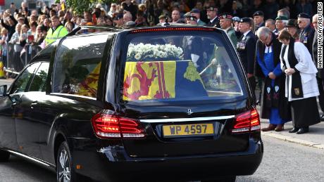 People lined the street as the hearse carrying the Queen's coffin passed through the Scottish village of Ballater.