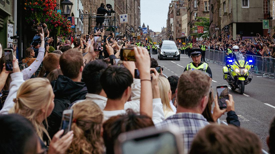 Crowds watch the hearse carrying the Queen&#39;s coffin as it makes its way down the Royal Mile in Edinburgh.