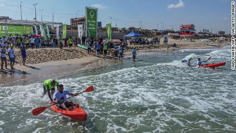 Palestinians take part in a local canoeing championship off the coast of Gaza City, on Sunday.