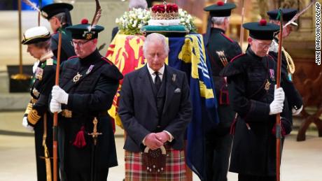 Charles III, center, and other members of the royal family hold a vigil at the Queen&#39;s coffin at St. Giles&#39; Cathedral on Monday.