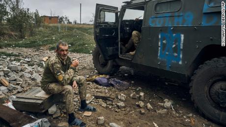 A Ukrainian soldier takes a break to rest in the freed territory in the Kharkiv region, Ukraine, on Monday.