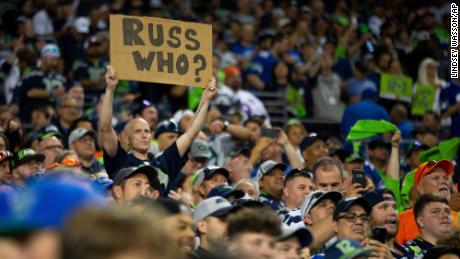 A Seattle Seahawks fan holds a sign referencing Wilson during the second half. 