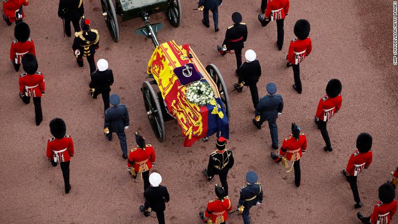 Queen Elizabeth II&#39;s flag-draped coffin is taken in procession on a gun garriage of The King&#39;s Troop Royal Horse Artillery from Buckingham Palace to Westminster Hall on September 14, 2022.