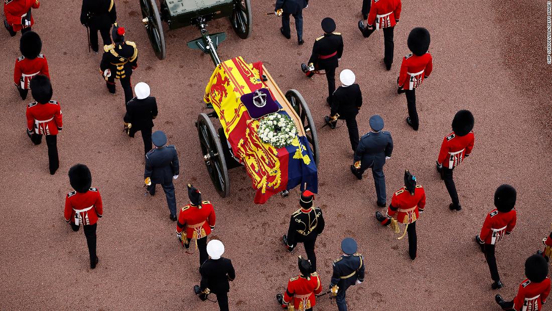 The coffin of Queen Elizabeth II is adorned with the Imperial State Crown and covered with the Royal Standard during its procession to Westminster Hall on Wednesday, September 14.