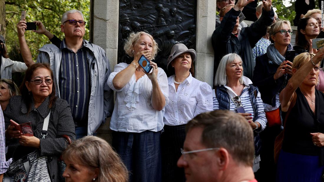 People watch as the Queen&#39;s coffin passes them on Wednesday.