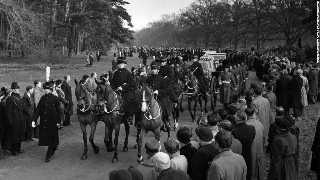 A gun carriage carrying the King&#39;s coffin makes its way from Sandringham to Wolferton station in Norfolk, England, before being transported to London on February 11, 1952.