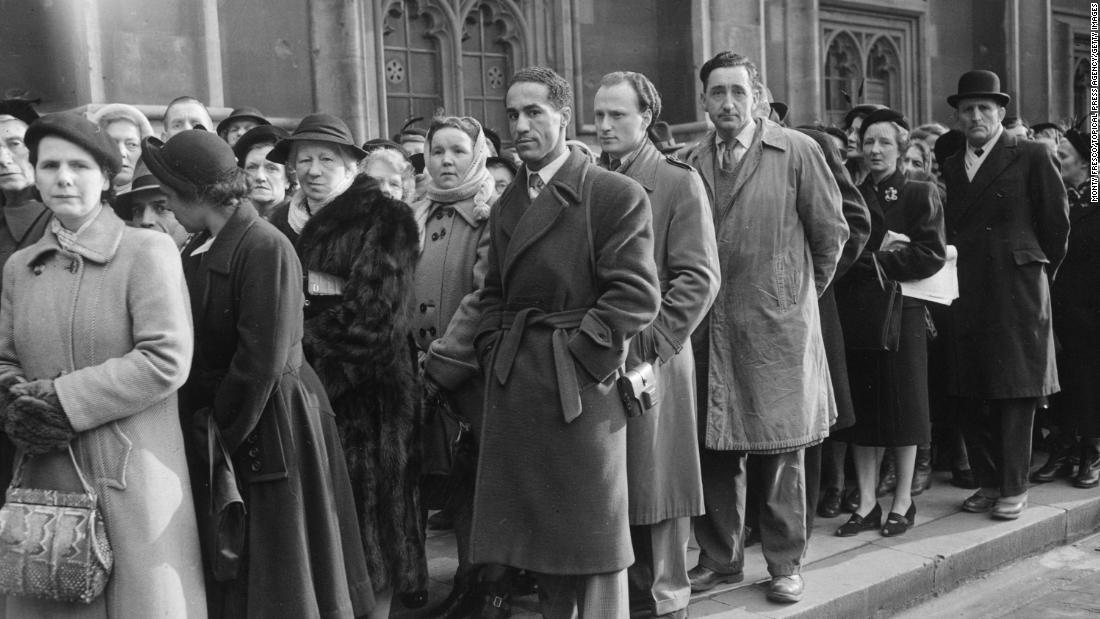 British boxer Alex Buxton, center, is among the mourners waiting in line to pay their respects to the King in Westminster Hall.