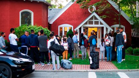 Immigrants gather with their belongings outside St. Andrews Episcopal Church, Wednesday Sept. 14, 2022, in Edgartown, Mass., on Martha&#39;s Vineyard. Florida Gov. Ron DeSantis on Wednesday flew two planes of immigrants to Martha&#39;s Vineyard, escalating a tactic by Republican governors to draw attention to what they consider to be the Biden administration&#39;s failed border policies. (Ray Ewing/Vineyard Gazette via AP)