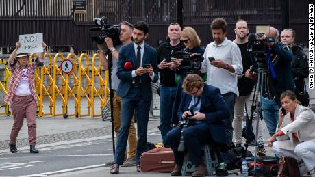 An anti-monarchy protester addresses the media outside the Houses of Parliament on Monday.