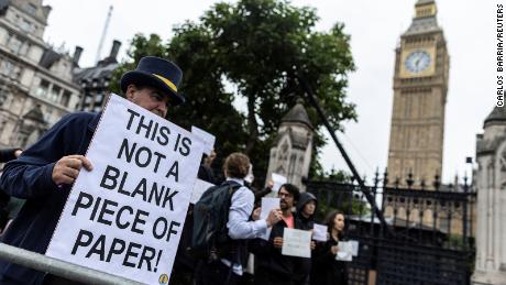 Protesters gathered outside the Houses of Parliament on Tuesday, many carrying blank placards.