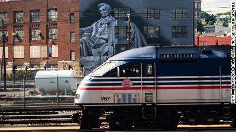 A train is seen near a mural of Abraham Lincoln is seen in the Eckington neighborhood of Washington, D.C., on Monday, August 22, 2022. 