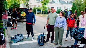 Immigrants gather with their belongings outside St. Andrews Episcopal Church, Wednesday Sept. 14, 2022, in Edgartown, Mass., on Martha&#39;s Vineyard. Florida Gov. Ron DeSantis on Wednesday flew two planes of immigrants to Martha&#39;s Vineyard, escalating a tactic by Republican governors to draw attention to what they consider to be the Biden administration&#39;s failed border policies. (Ray Ewing/Vineyard Gazette via AP)