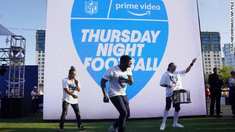 FILE - Robert &quot;Bojo&quot; Ackah, center, and Fik-Shun, left, perform during the announcement of the first Thursday Night Football on Prime Video matchup featuring the San Diego Chargers at Kansas City Chiefs at the 2022 NFL Draft on Thursday, April 28, 2022 in Las Vegas. The Thursday night, Sept. 15 game between the Los Angeles Chargers and Kansas City Chiefs kicks off Amazon Prime Video&#39;s 11-year agreement with the NFL to carry &quot;Thursday Night Football&quot;. (AP Photo/Vera Nieuwenhuis, File)