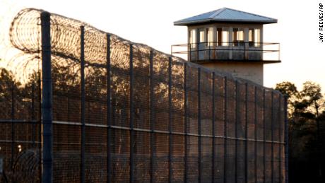 The sun sets in January behind Holman Correctional Facility, home to Alabama's death row.