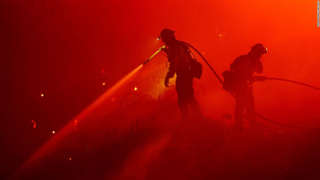 Firefighters work in Foresthill, California, on Tuesday, September 13. The Mosquito Fire is now California's biggest wildfire this year.