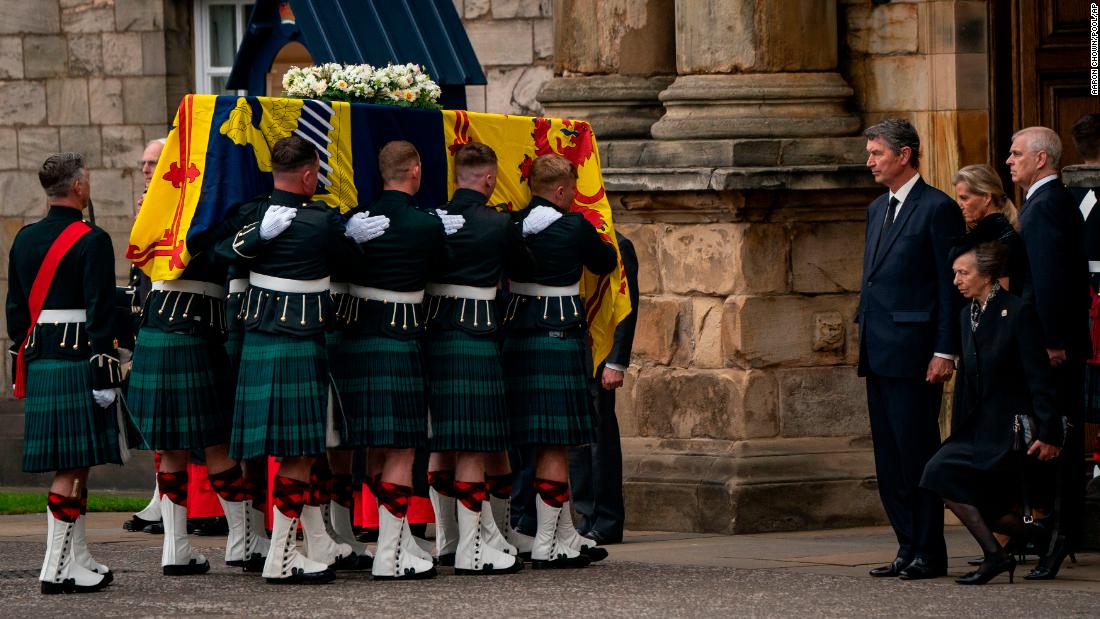 Britain's Princess Anne curtseys as the coffin of her mother, Queen Elizabeth II, enters the Palace of Holyroodhouse in Edinburgh, Scotland on Sunday, September 11. Thousands lined the route of the royal cortege that passed through the Scottish countryside and the cities of Aberdeen and Dundee.