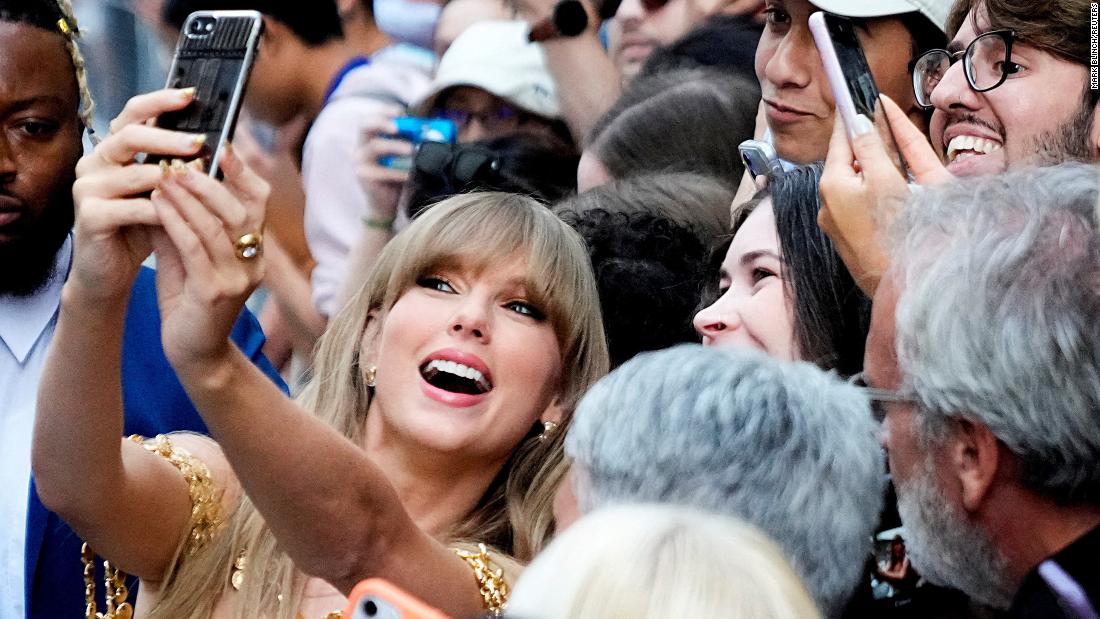 Singer Taylor Swift takes a selfie with fans as she arrives at the Toronto International Film Festival on Friday, September 9.
