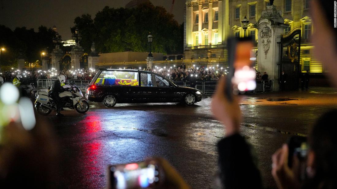 A hearse carrying the coffin of Britain's Queen Elizabeth II arrives at Buckingham Palace in London on Tuesday, September 13.