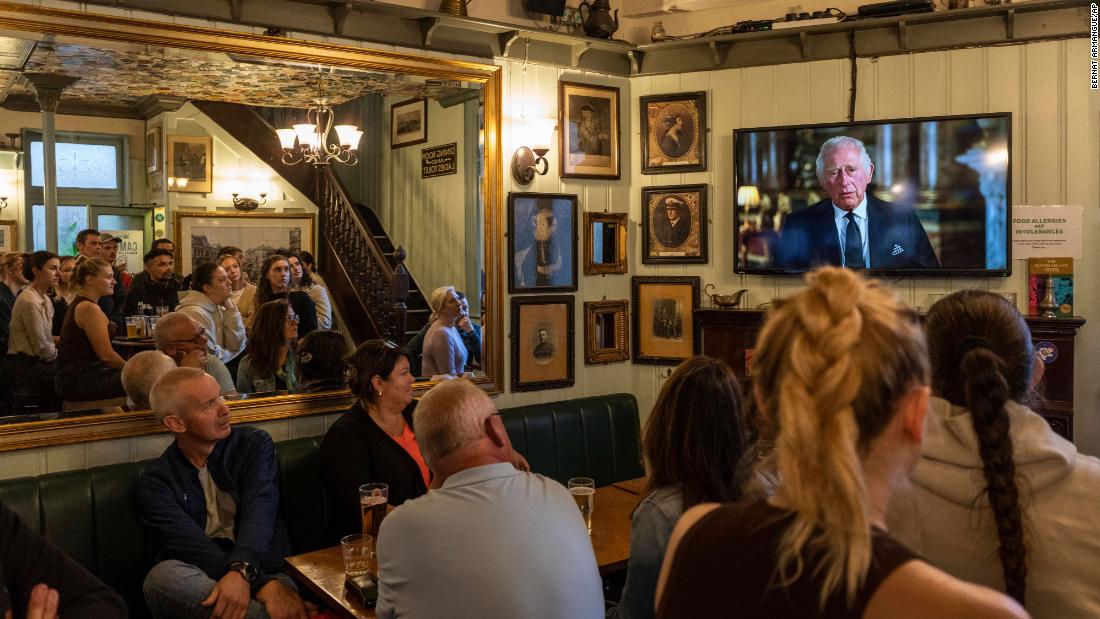 People inside a London pub watch a televised speech by King Charles III on Friday, September 9. &quot;As the Queen herself did with such unswerving devotion, I too now solemnly pledge myself, throughout the remaining time God grants me, to uphold the Constitutional principles at the heart of our nation,&quot; he said.