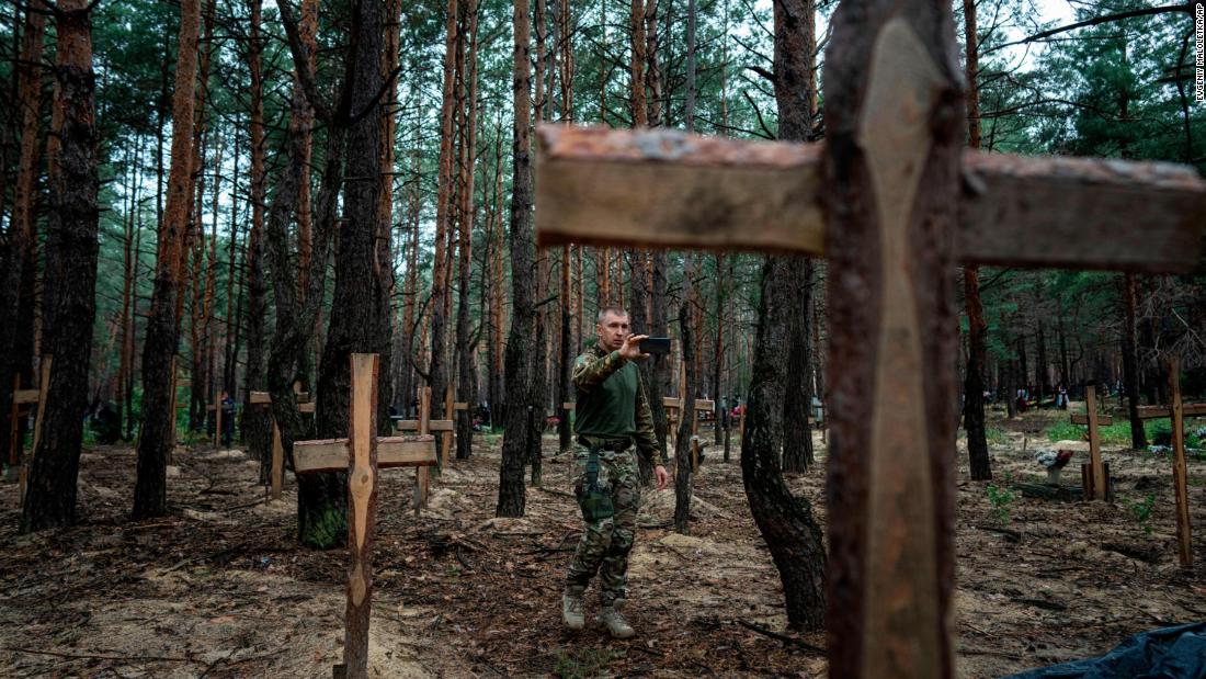 Ukrainian officials say some of the remains found at a mass burial site in the liberated city, including children, likely underwent violent deaths