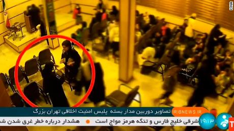 A video, broadcast by Iranian state television, shows the alleged moment Mahsa Amini, 22, facing the camera in the red circle, collapses after being arrested by the 