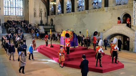 Mourners pay their respects as they file past the Queen&#39;s coffin inside Westminster Hall.