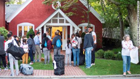 Venezuelan migrants stand outside St. Andrew&#39;s Church in Edgartown, Massachusetts, on September 14, 2022.