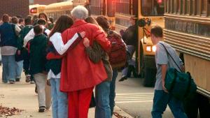 FILE - Students arriving at Heath High School in West Paducah, Ky., embrace an unidentified adult on Tuesday, Dec. 2, 1997, after student Michael Carneal opened fire at the school the day before, leaving three students dead and five wounded. In the quarter century that has passed, school shootings have become a depressingly regular occurrence in the U.S. Carneal&#39;s upcoming parole hearing in September 2022, raises questions about the appropriate punishment for children who commit heinous crimes. Even if they can be rehabilitated, many wonder if it is fair to the victims for them to be released. (AP Photo/Mark Humphrey, File)