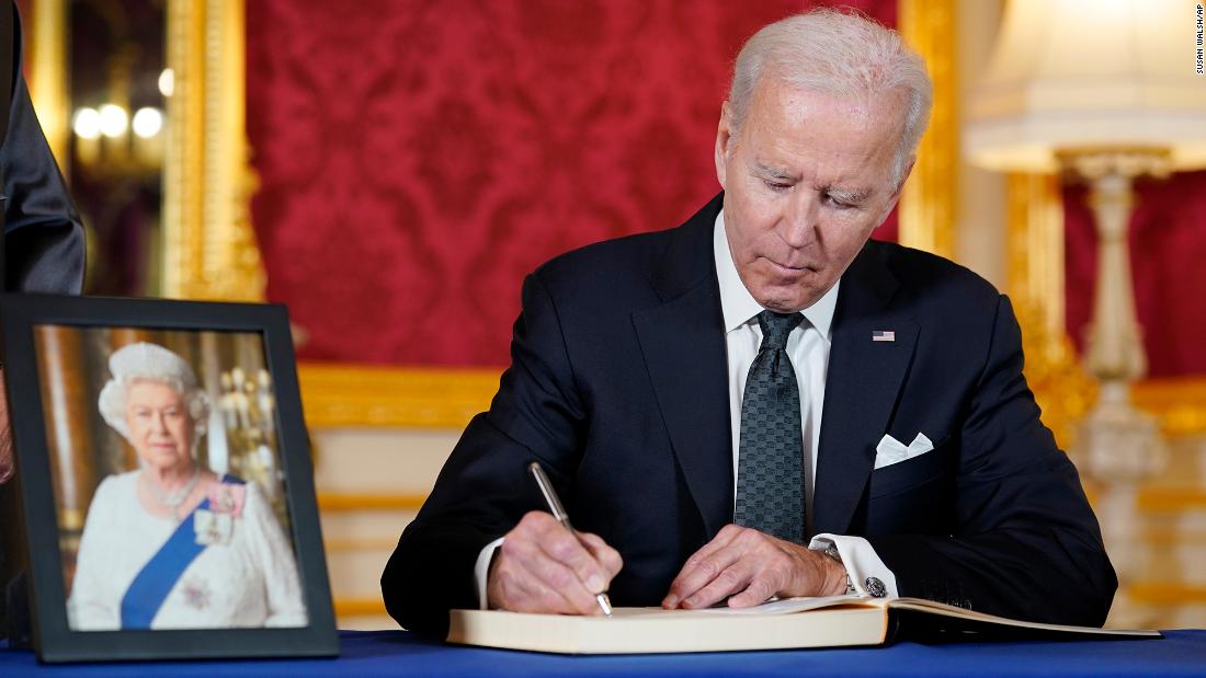 President Biden signs a book of condolences at London&#39;s Lancaster House on Sunday.