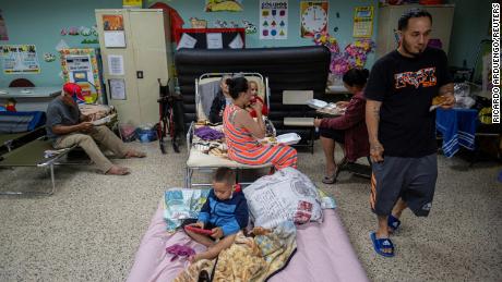 Evacuees are seen in a classroom at a public school being used as a shelter as Hurricane Fiona and its heavy rains approach Guayanilla, Puerto Rico on Sunday.