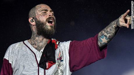 Post Malone suffers bruised ribs after falling through a hole on stage in St. Louis