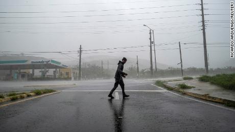 A man stands in the strong winds of Hurricane Fiona in Ponce, Puerto Rico September 18, 2022. REUTERS/Ricardo Arduengo