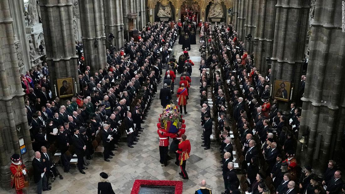 Queen Elizabeth's funeral ends with lone piper and her coffin procession moves on to Wellington Arch