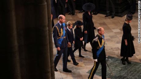 Prince William, his children, Prince George and Princess Charlotte, and wife, Catherine, Princess of Wales, arrive to take their seats inside the abbey.
