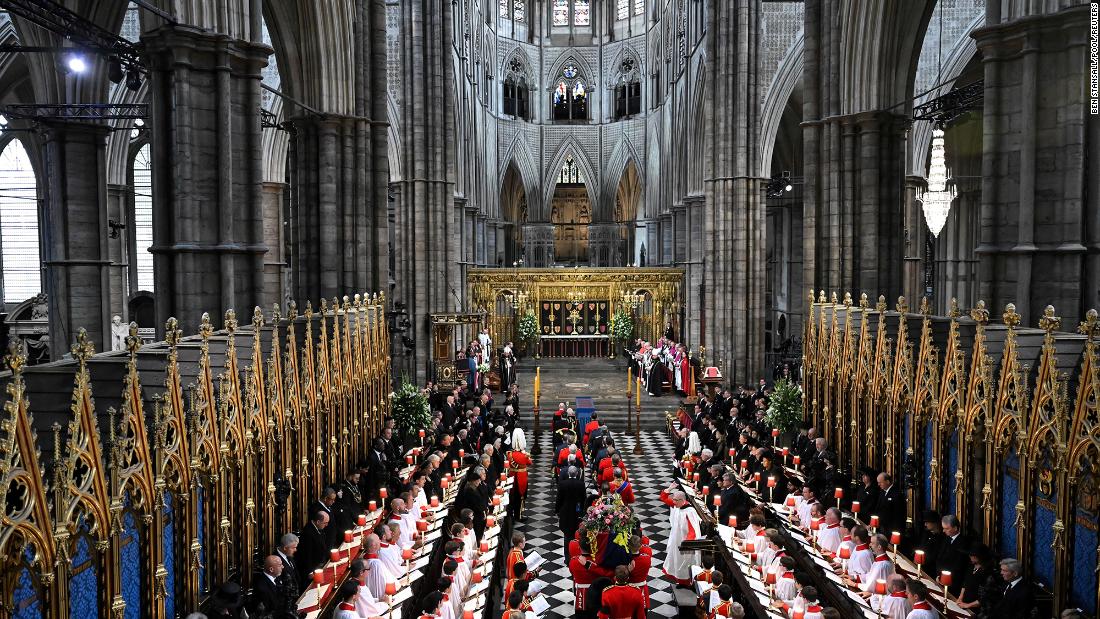 The Queen&#39;s coffin is carried into Westminster Abbey.
