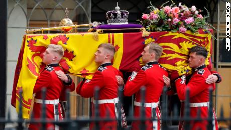 Pallbearers carry the coffin of Queen Elizabeth II, draped in the Royal Standard with the Imperial State Crown during her State Funeral at Westminster Abbey in London, Monday, Sept. 19, 2022. The Queen, who died aged 96 on Sept. 8, will be buried at Windsor alongside her late husband, Prince Philip, who died last year. ( James Manning/Pool Photo via AP)