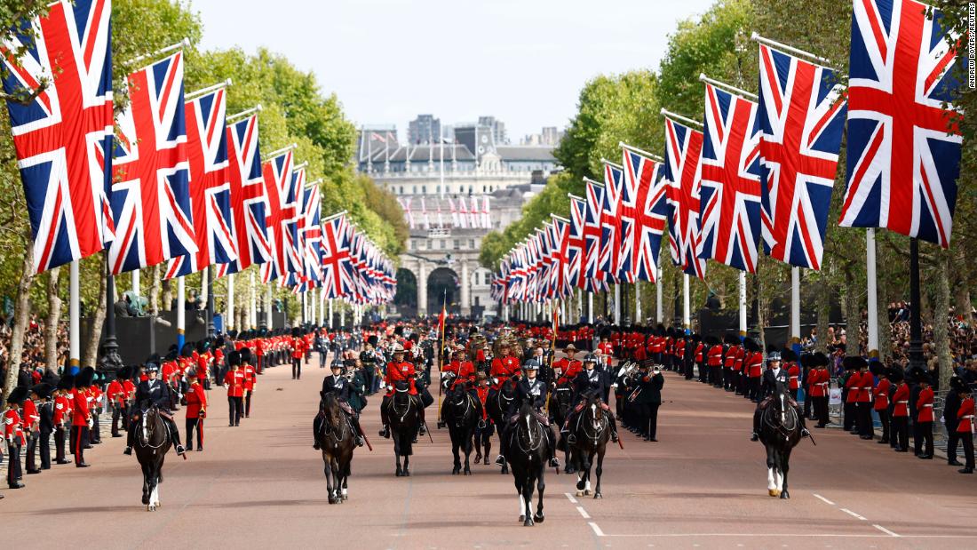 The Queen&#39;s funeral procession marches down The Mall after the service at Westminster Abbey.
