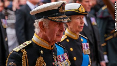 Britain's King Charles III, front, and Anne, Princess Royal, right, walk behind the Queen's coffin.