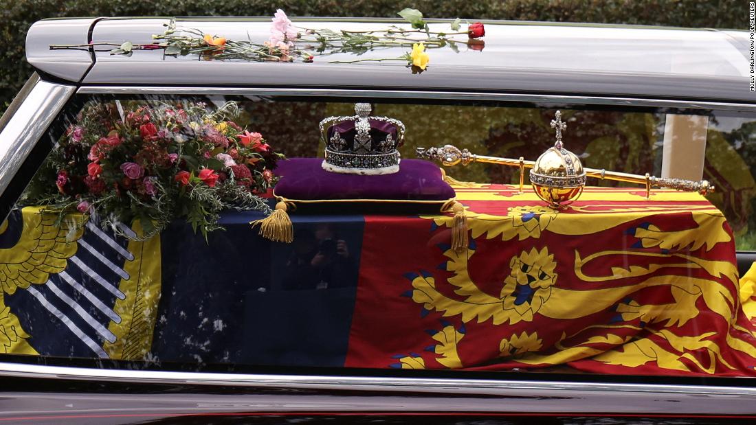 The Queen&#39;s coffin can be seen inside a hearse as it is driven along Albert Road in Windsor.