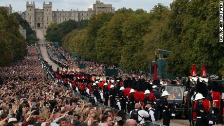 Crowds line the Long Walk outside Windsor Castle to watch the procession.