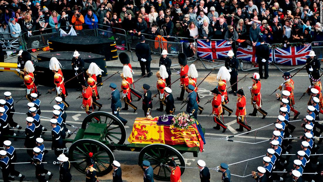 A gun carriage transports the Queen&#39;s coffin after her funeral service at Westminster Abbey.