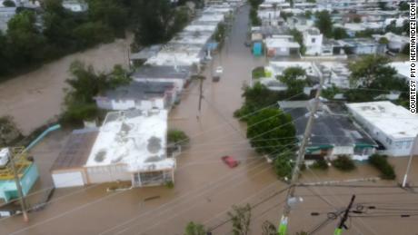Cars and homes were submerged in Puerto Rico, where there was still no electricity.