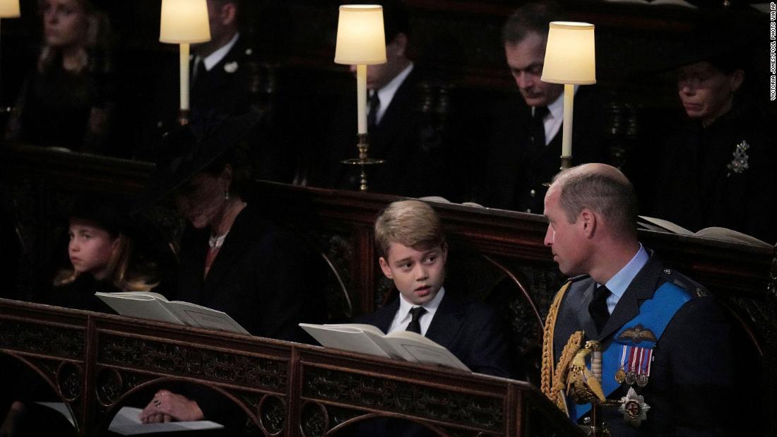 Prince William looks at his son Prince George as he attends the committal service with his wife Catherine, the Princess of Wales, and their daughter, Princess Charlotte.