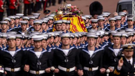 The coffin of Queen Elizabeth II is escorted by Royal Navy sailors as it travels from Westminster Abbey to Wellington Arch after the monarch&#39;s funeral in London on Monday, September 19.